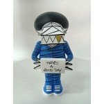 Vinyl art toy of a man in blue clothes holding a sign Vinyl art toy of a man in blue clothes holding a sign