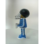 Vinyl art toy of a man in blue clothes holding a sign Vinyl art toy of a man in blue clothes holding a sign