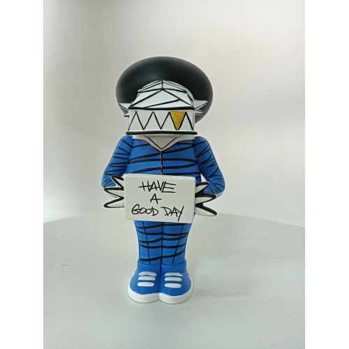Vinyl art toy of a man in blue clothes holding a sign Vinyl art toy of a man in blue clothes holding a sign