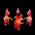 a kaiju sofubi of pink monster with gun