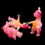 a kaiju sofubi of pink monster with gun