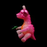 a kaiju sofubi of pink monster with gun